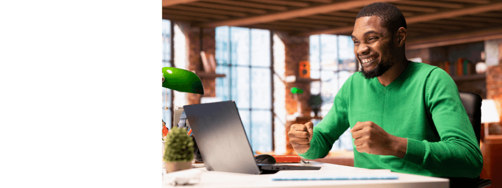 Professional celebrating at desk